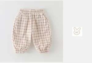 Detail of toddler boy plaid cotton pants featuring elastic waist and cuffs with side pockets