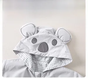 Detail of baby hooded windbreaker featuring cute animal ears and checkered lining