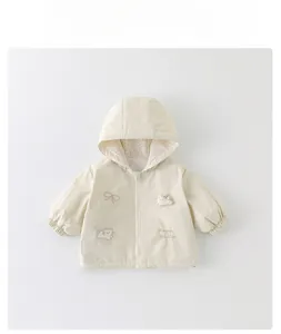 Detail of toddler hooded jacket with floral lining and magic rabbit embroidery