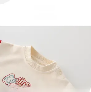 Close-up of baby boy sweater neck with snap buttons and high-quality embroidery