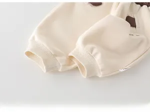 Détail des bords-côtes et de la texture du tissu du pantalon de jogging beige