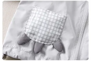 Detail of boys light grey jacket with plaid pocket and creative 3D claw design
