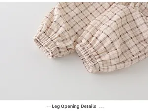 Close-up of boys' beige plaid cotton pants featuring elastic cuffs and detailed stitching
