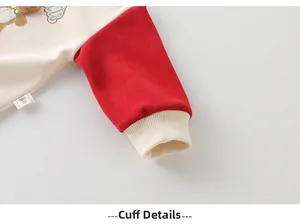 Detail of baby sweatshirt ribbed cuffs with contrast red sleeves and soft cotton fabric