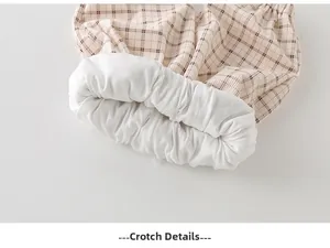 Macro shot of toddler beige plaid pants featuring soft inner lining and crotch stitching