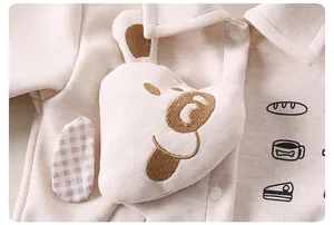 Detail of baby ribbed knit outfit featuring a 3D plush puppy and cartoon bread drawings