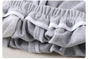 Detailed close-up of children gray knitted trousers with elastic waistband and reinforced seams