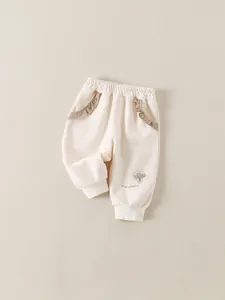 Pantaloni sportivi neonata bianco panna con ricamo a fungo e rifiniture con volant