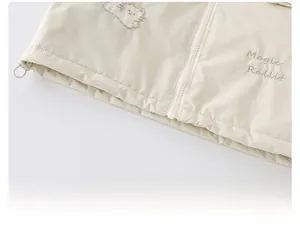 Close-up of girls' floral jacket hem featuring cartoon embroidery and adjustable drawstring