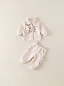Cute beige two-piece toddler set with cartoon puppy mascot and embroidered text