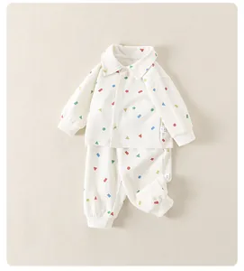 Detail of baby cotton pajamas with colorful geometric prints and soft ribbed cuffs