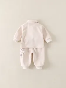 Cute two-piece baby track suit with dog cartoon pattern and plaid pocket accents