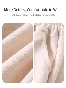 Off-white ribbed knit trousers for kids featuring elastic waistband and side pockets