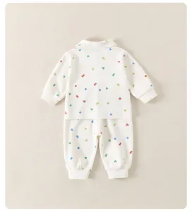 Detailed flat lay of beige ribbed cotton toddler set with colorful geometric patterns