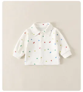 Detail of baby long-sleeve knit shirt with colorful geometric shapes and button closure