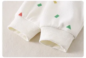 Close-up of children's knit sweater ribbed cuffs with colorful geometric patterns