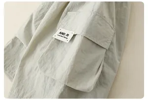 Detail of baby boys light green cargo outfit showing flap pocket and textile label