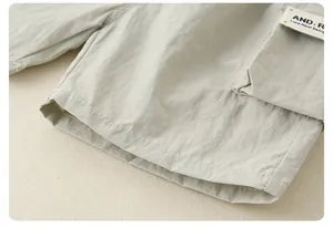 Detail of lightweight boys' cargo shorts with a brand label and clean stitching work