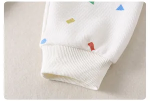 Detail of waffle knit elastic cuffs and colorful geometric patterns on children pajamas