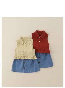 Detail of girls sleeveless top with ruffle waist and denim skirt two-piece summer set
