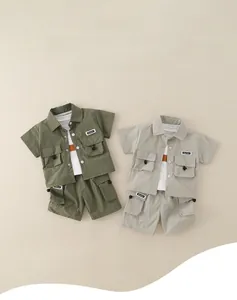 Flat lay of boys summer cargo set showing olive and khaki short sleeve shirts and shorts