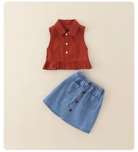 Detail of red-brown sleeveless shirt with ruffles and light blue denim skirt