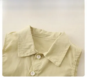 Detail of the light beige shirt collar with white buttons and clean stitching on cotton fabric