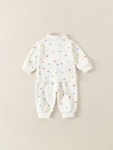 Two-piece baby loungewear set with colorful geometric patterns in cream waffle fabric