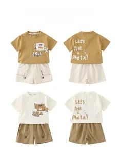 Detail view of boys' summer cotton sets with cartoon pockets and typographic prints