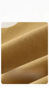 Close-up of mustard yellow knit fabric for boys clothing with soft combed cotton texture