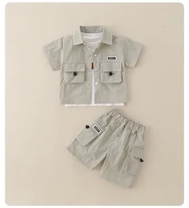 Flat lay of boy's summer utility set featuring short-sleeve shirt and matching cargo shorts