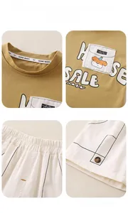 Detail of mustard yellow t-shirt with cartoon dog pocket and striped elastic shorts