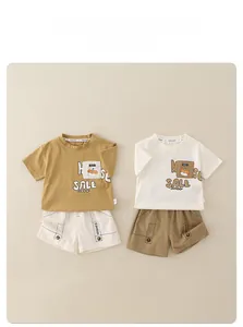 Flat lay of cotton t-shirt and shorts sets with cartoon prints and button details