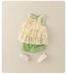 Close-up of floral tiered ruffle top and green shorts summer outfit for toddler girls