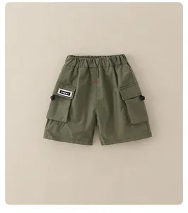 Detail of army green boys cargo shorts featuring elastic waist and side utility pockets