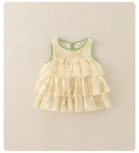 Close-up of lightweight yellow floral girl dress with ruffled tiers and kitted neckline