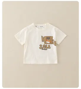 Detailed close-up of boys cream cotton t-shirt with cartoon pocket and sale print