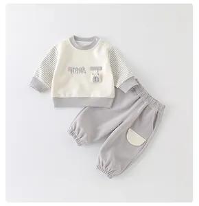 Detail of infant long-sleeved set with bear patch and Break Rules embroidery