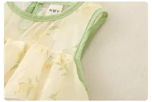 Detail of baby girl floral top showing kbt brand tag and breathable chiffon fabric