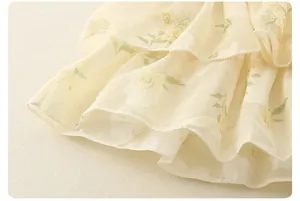 Detail of floral chiffon fabric with layered ruffles and delicate rolled hem stitching