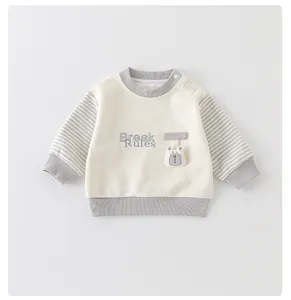 Close-up of cotton baby sweatshirt with bear patch and Break Rules embroidery