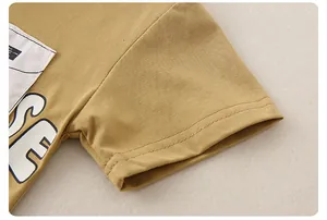 Detailed close-up of mustard yellow cotton t-shirt sleeve with double-needle stitching