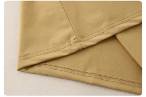 Detailed macro view of the neat double-needle stitching on yellow cotton jersey fabric