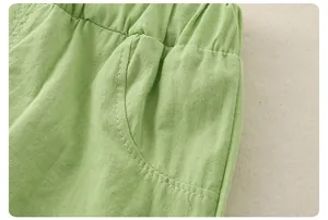 Detail of light green cotton linen shorts showing elastic waistband and stitching