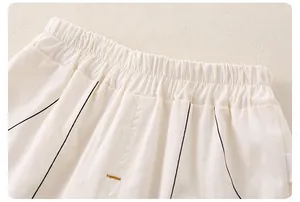 Detail of baby boys summer shorts showing elastic waistband and black vertical stripes