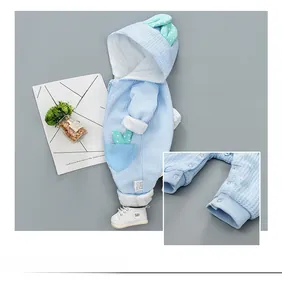Detail of light blue waffle knit baby romper featuring snap buttons and ribbed cuffs