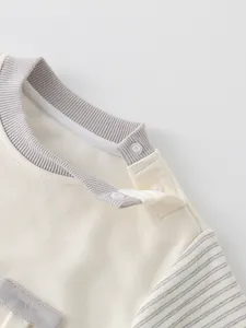 Cute cotton baby tracksuit featuring ribbed collar and shoulder snap buttons