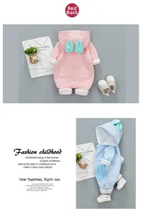Detail of pink and blue waffle knit baby rompers with adorable polka dot rabbit ears