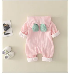 Detailed view of pink waffle fabric baby romper with cute patterned hood ears