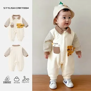 Detail of baby romper with tiger patch, striped sleeves, and breathable soft cotton fabric